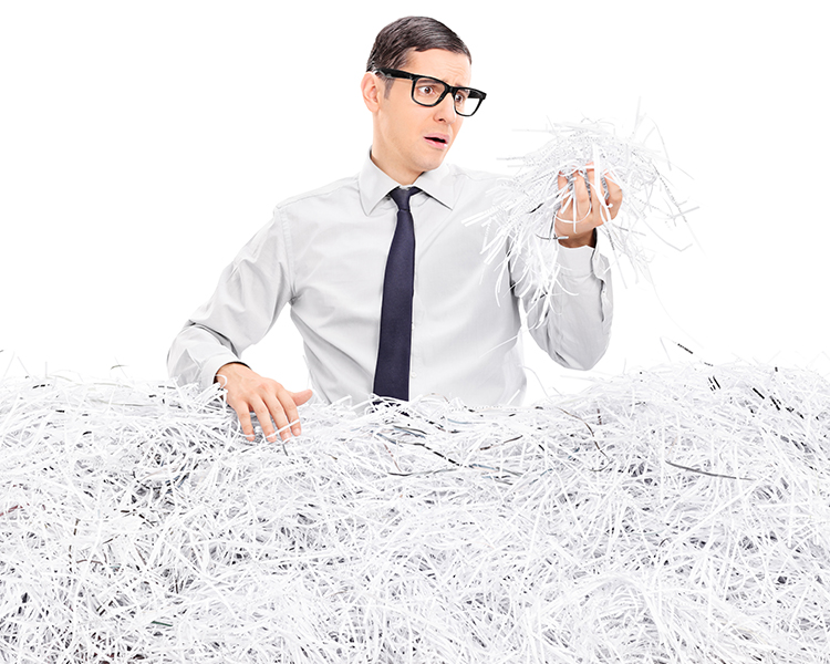 Man searching through pile of paper